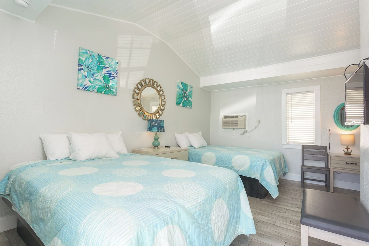 Bright coastal guest room at Paradise Inn.